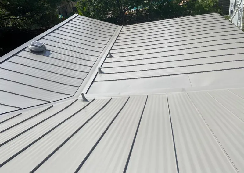 Solar attic fan installed on a metal roof for Roof Ventilation in Cottage Grove